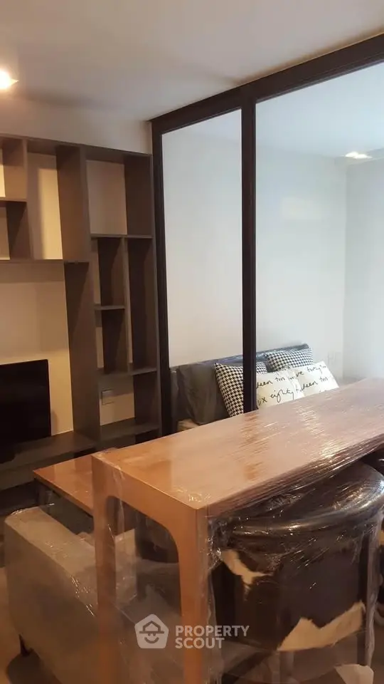 Modern living room with stylish furniture and open shelving, perfect for urban living.
