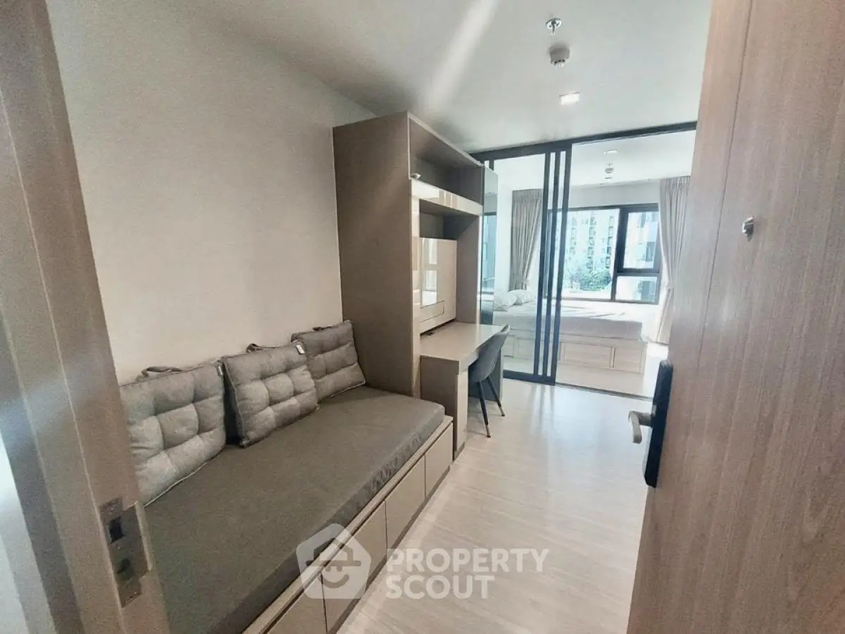 Modern compact apartment with cozy living area and bedroom view