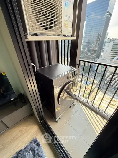 Modern balcony with washing machine and city view, perfect for urban living convenience.