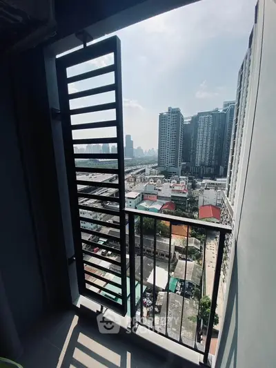 Stunning city view from modern high-rise balcony with sleek railing design.
