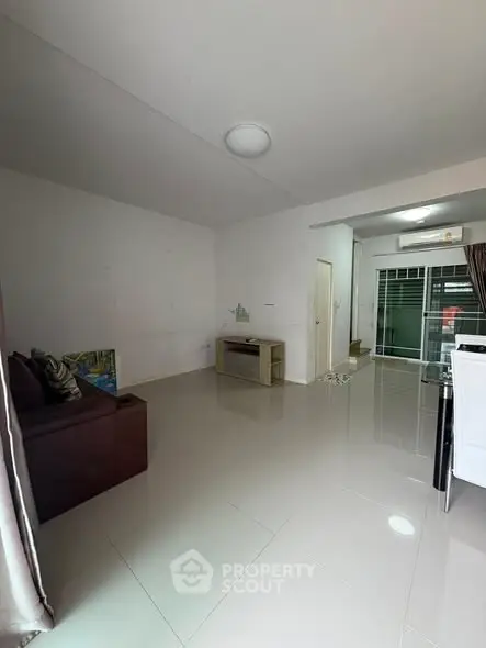 Spacious living room with modern minimalist design and large windows