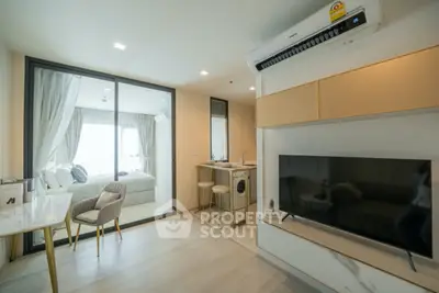 Modern living room with open layout and stylish decor, featuring a sleek TV setup and cozy seating area.
