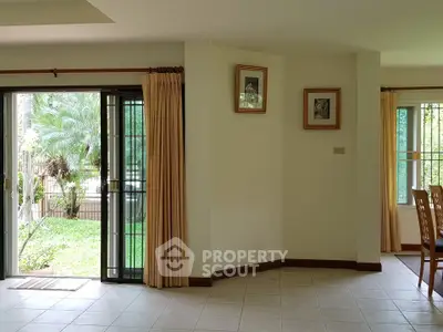 Spacious living room with garden view and elegant dining area