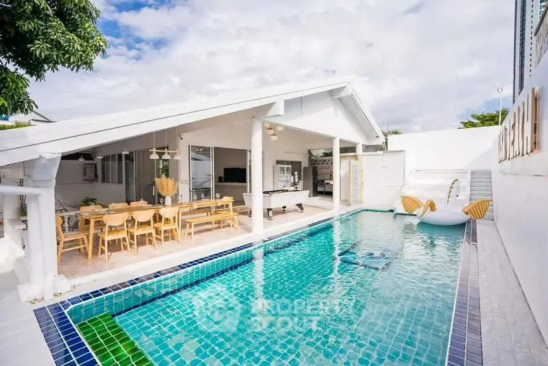 Stunning modern home with a luxurious pool and spacious outdoor dining area.
