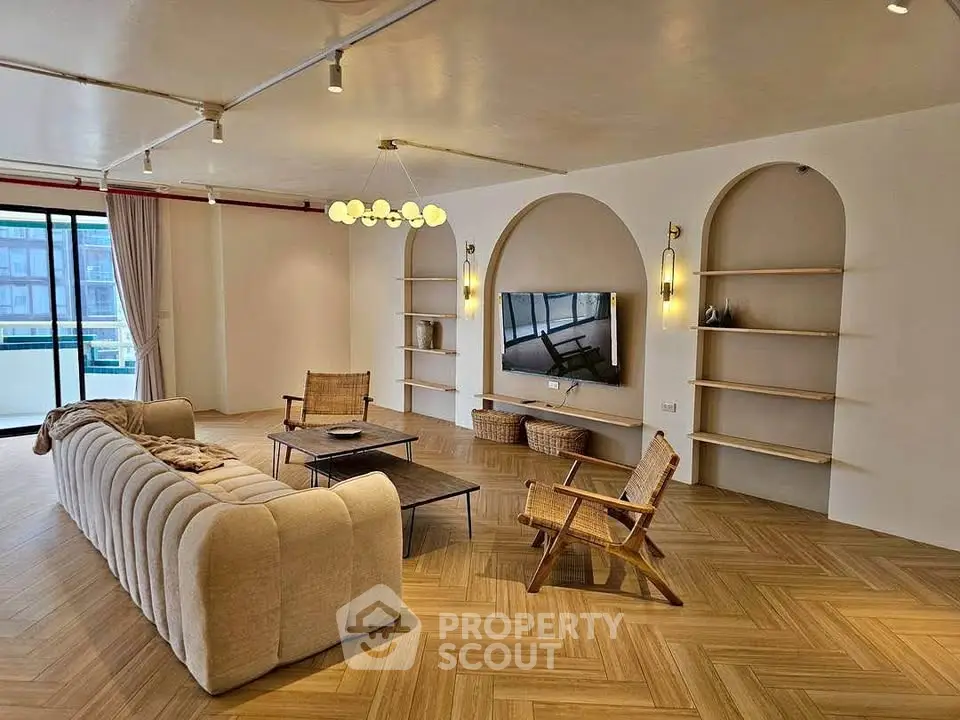 Spacious living room with modern decor and large windows offering natural light.