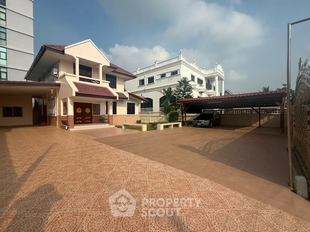 Spacious villa with large driveway and carport in a serene neighborhood