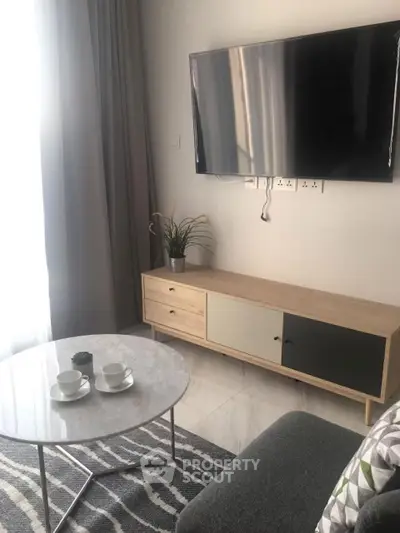 Modern living room with sleek TV setup and stylish coffee table