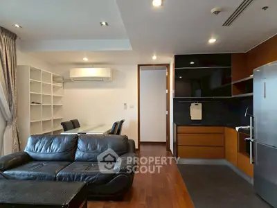 Modern open-plan living room with sleek kitchen and leather sofa