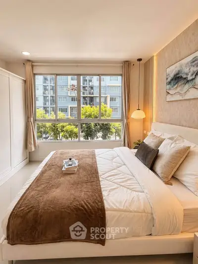 Spacious bedroom with large window and modern decor in a high-rise apartment.