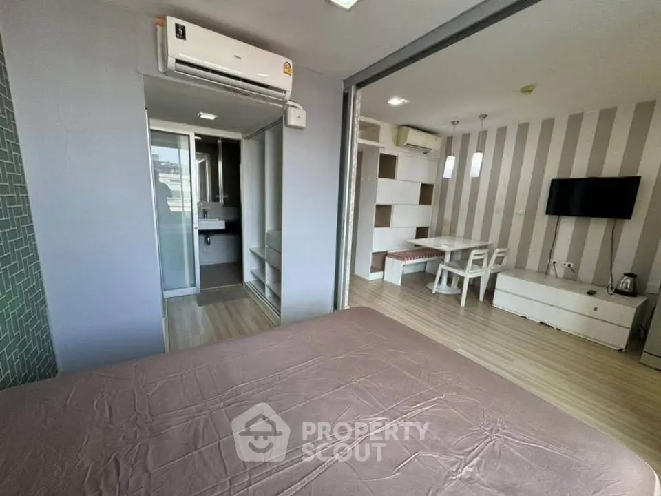 Modern studio apartment with open layout, featuring a cozy living area and stylish decor.