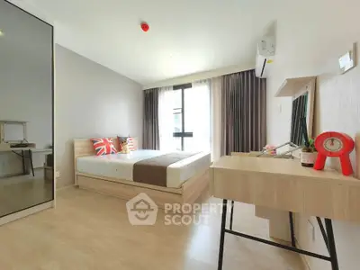 Modern bedroom with stylish decor and ample natural light in a contemporary apartment.