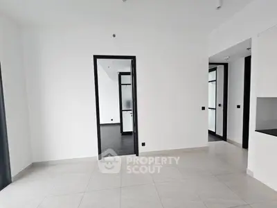 Spacious modern apartment interior with sleek tile flooring and minimalist design.