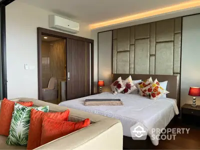 Luxurious bedroom with modern decor and ensuite bathroom in a stylish apartment.