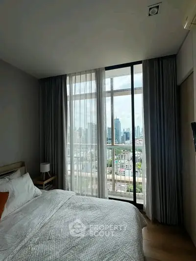 Luxurious bedroom with stunning city view through floor-to-ceiling windows, elegant decor and natural light.