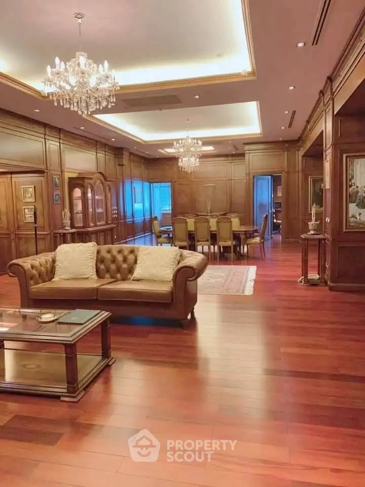 Luxurious living room with elegant wooden decor and chandelier lighting