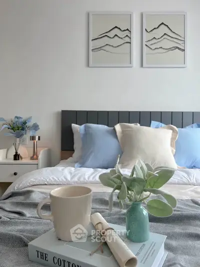 Cozy bedroom with stylish decor, featuring a plush bed, elegant artwork, and a serene ambiance.