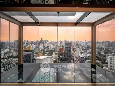 Stunning panoramic city view from a modern high-rise building with floor-to-ceiling glass windows.