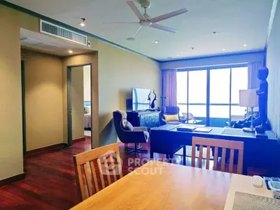 Spacious living room with modern decor and large windows offering natural light.