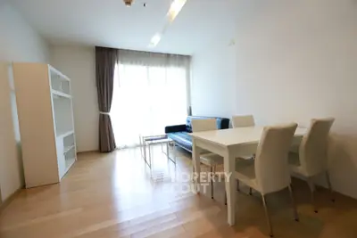 Spacious modern living room with wooden flooring and natural light