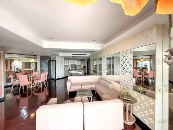 Spacious living room with elegant dining area and modern open kitchen layout.