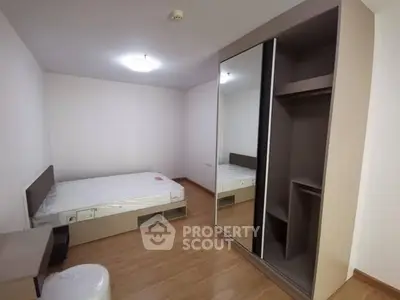 Spacious bedroom with modern wardrobe and cozy bed in minimalist design.