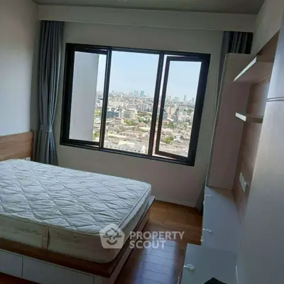 Modern bedroom with large window offering stunning city view