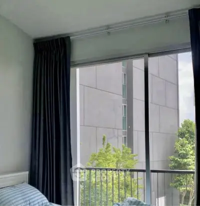 Modern bedroom with large window and urban view, featuring sleek curtains and contemporary design.