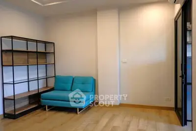Modern living room with blue sofa and stylish shelving unit