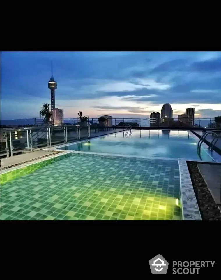 Stunning rooftop pool with city skyline view at sunset, perfect for luxury living.