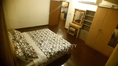 Cozy bedroom with wooden flooring and modern furniture