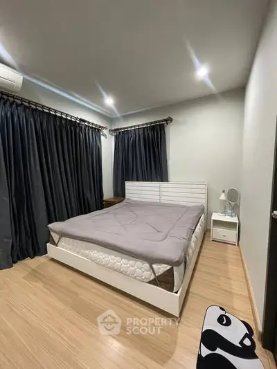 Modern bedroom with sleek design, featuring a comfortable bed and stylish curtains, perfect for relaxation.