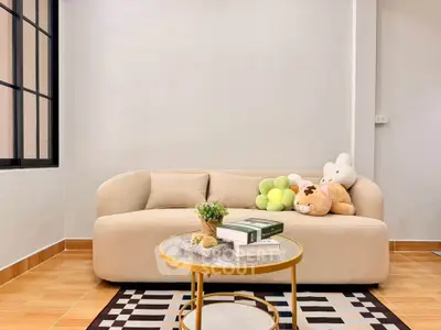 Chic living room with modern beige sofa and stylish decor in a cozy apartment setting.