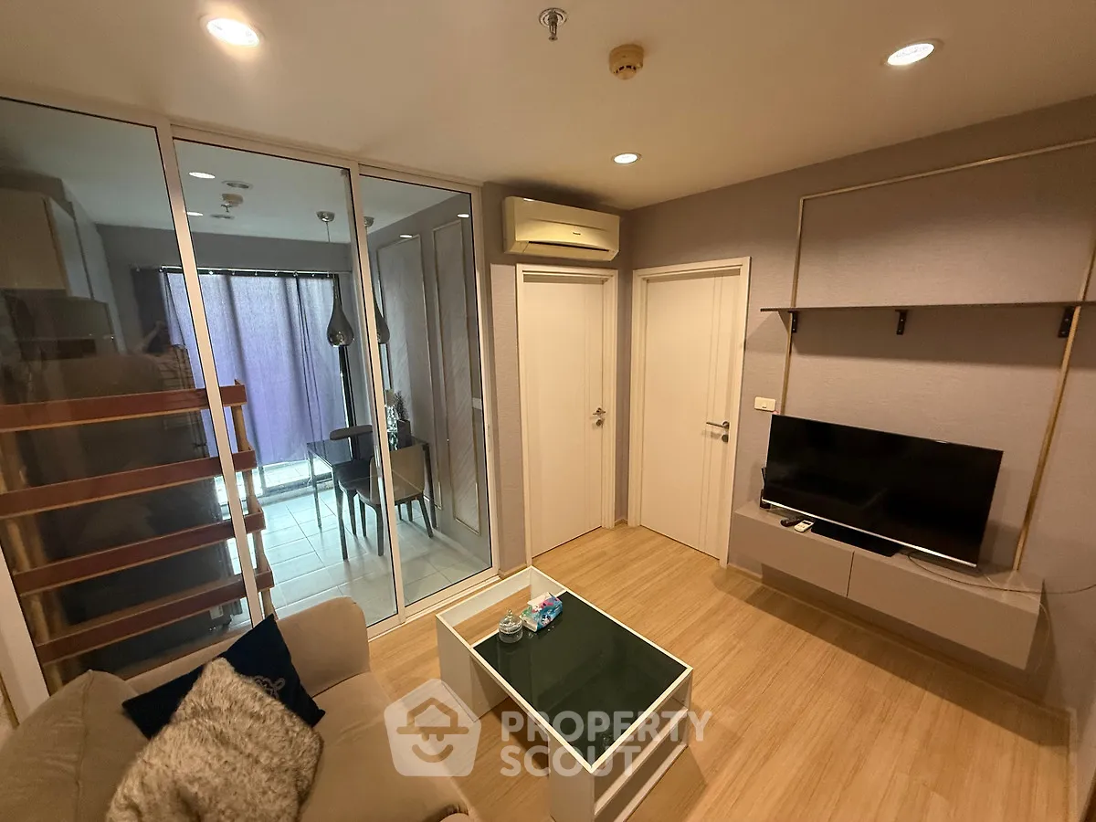 Modern living room with glass partition and cozy seating area