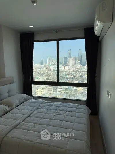 Modern bedroom with city view, featuring large window and cozy bedding in high-rise apartment.