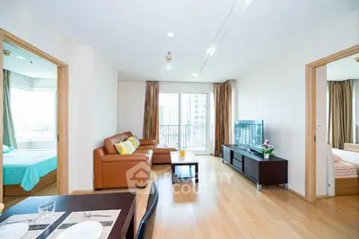 Spacious modern living room with wooden flooring and large windows