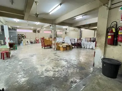 Spacious industrial warehouse with ample storage space and concrete flooring.