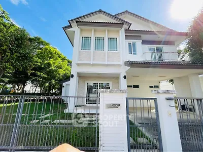Charming two-story house with a spacious garden and modern design, perfect for family living.