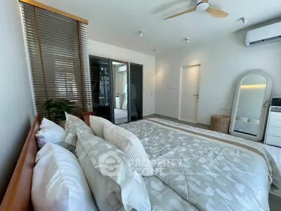 Spacious modern bedroom with stylish decor and natural light