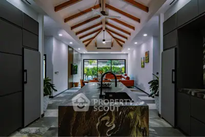 Stunning modern kitchen with open layout and high ceilings, featuring sleek cabinetry and a central island.