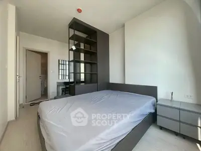 Modern bedroom with sleek furniture and ample natural light, perfect for a cozy living experience.