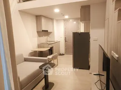 Modern studio apartment with compact kitchen and cozy living area