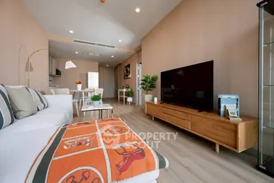 Modern living room with stylish decor and large flat-screen TV, perfect for relaxation and entertainment.