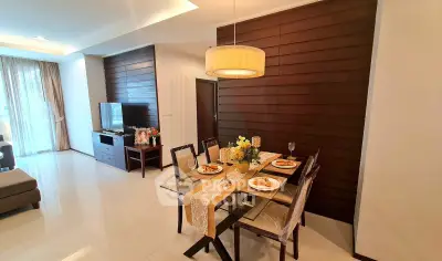 Elegant dining and living area with modern decor and natural light