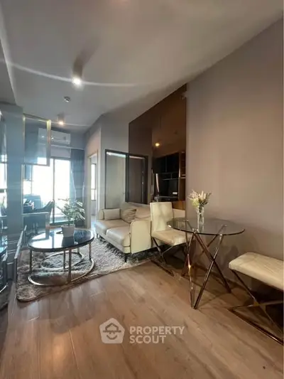 Modern living room with stylish decor and open layout, featuring elegant furniture and natural light.