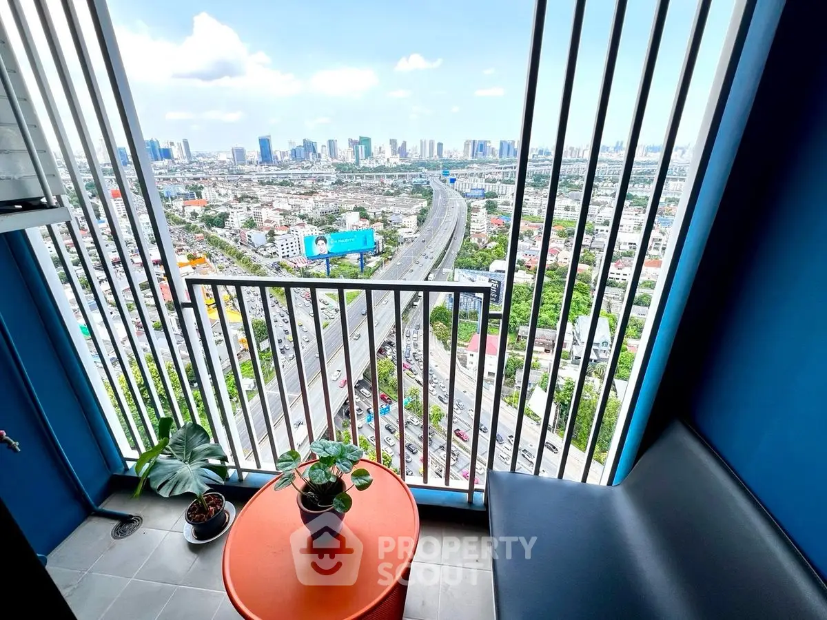 Stunning city view from modern balcony with vibrant decor and lush greenery.