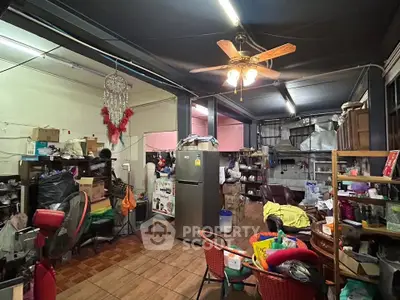 Spacious storage room with ceiling fan and ample shelving space