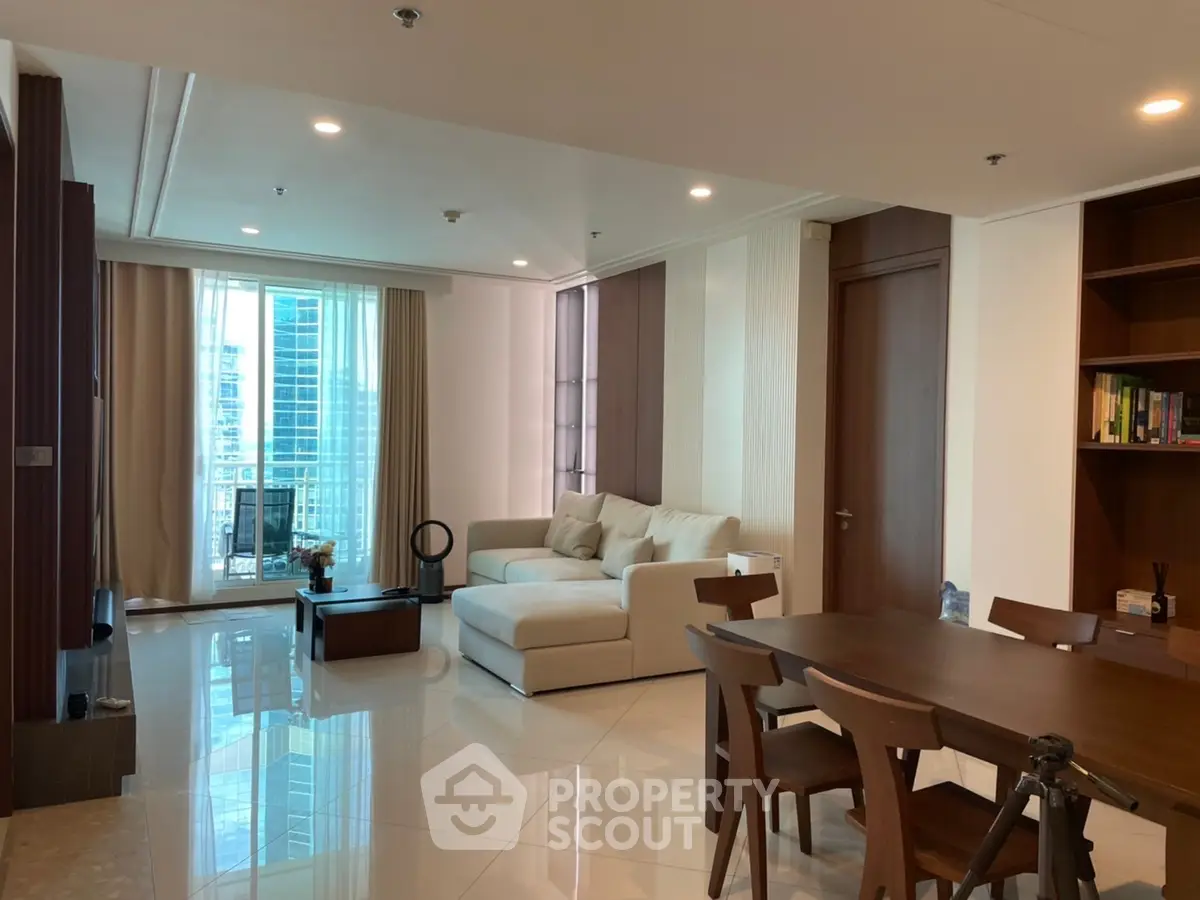 Spacious modern living room with elegant furniture and city view balcony
