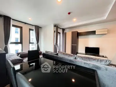 Modern living room with sleek furniture and large windows in a stylish apartment.