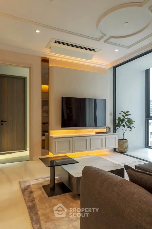 Luxurious modern living room with elegant decor and large TV, featuring stylish furniture and ambient lighting.