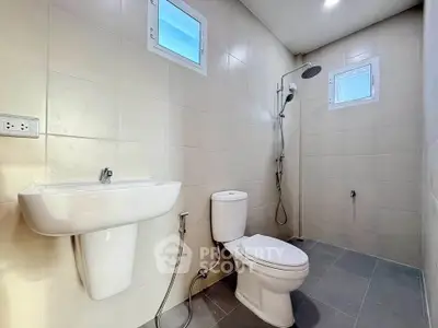 Modern bathroom with sleek fixtures and walk-in shower in a contemporary home.